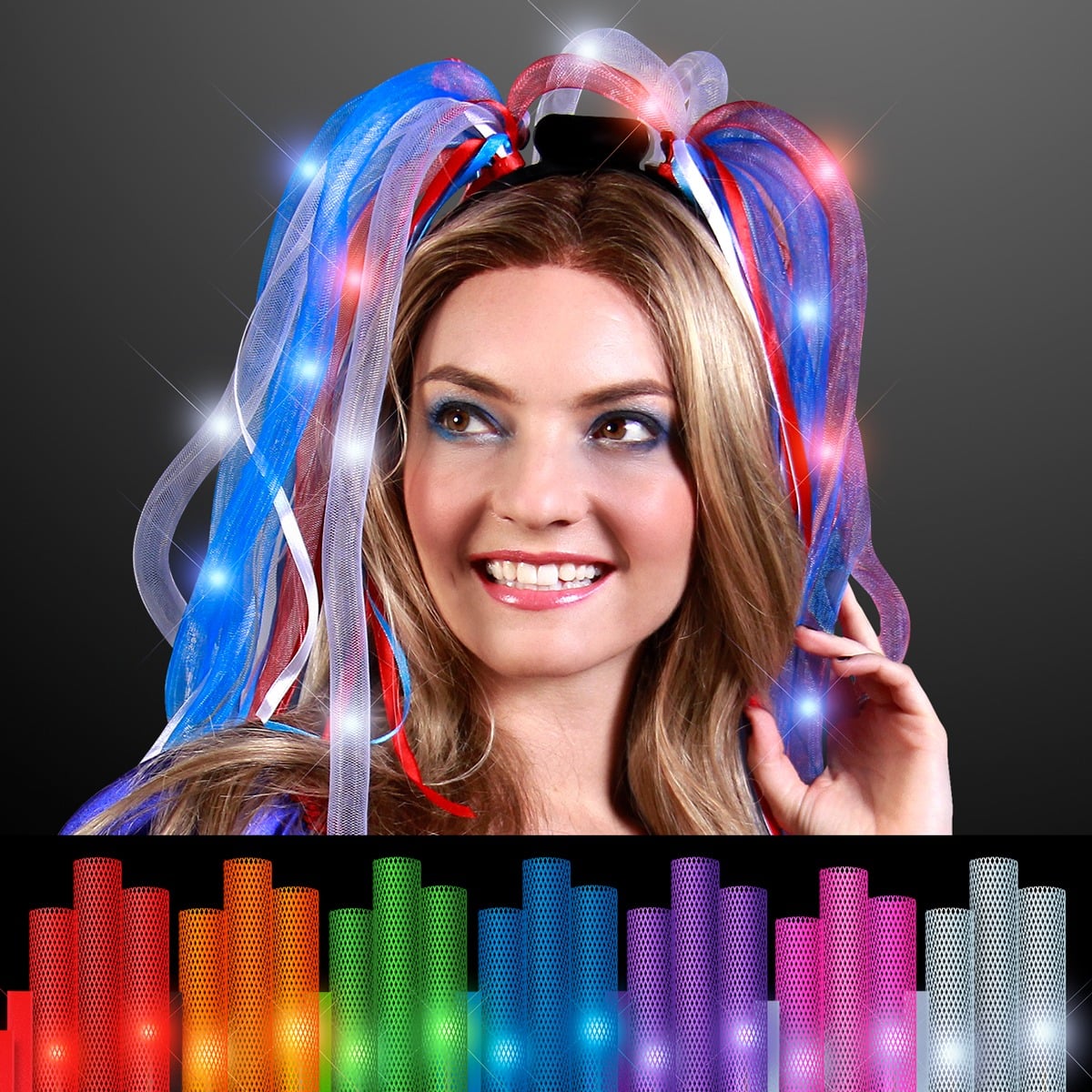 A smiling woman wears the Light Up Noodle Headband with glowing red, white, and blue ribbons. Below her, vibrant mesh ribbon rolls in assorted colors are shown against a black background.