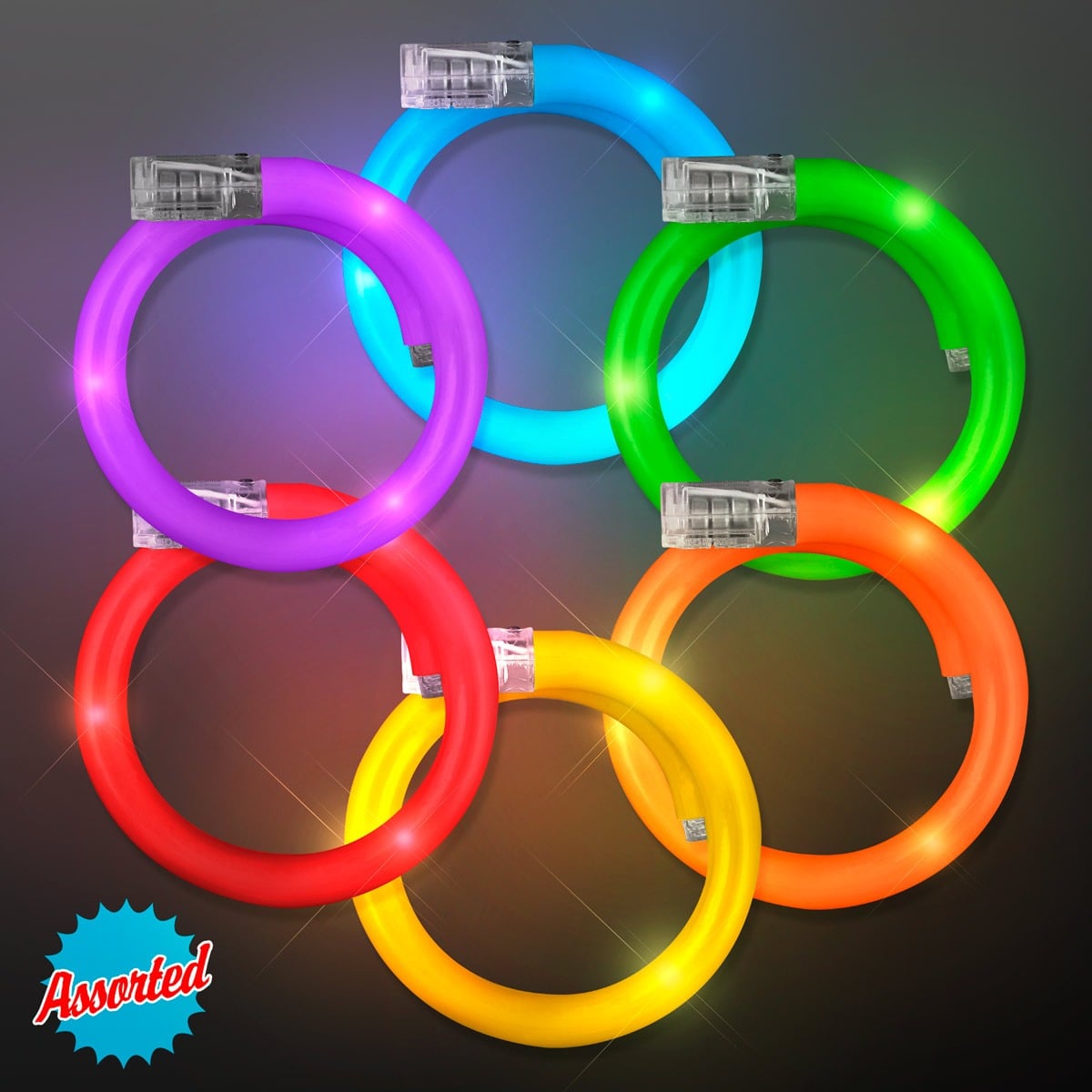 Six Light Up Tube Wrap Bracelets in assorted purple, blue, green, red, orange, and yellow are displayed in two rows on a dark gradient background. "Assorted" is highlighted in a burst at the bottom left.