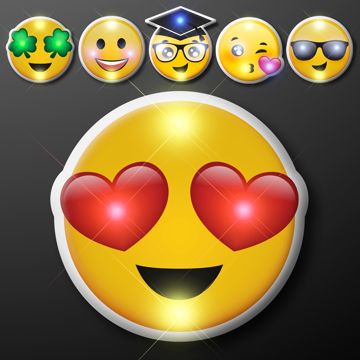 The Emoji LED Party Pins feature a large heart eyes emoji beneath five smaller emojis—shamrock eyes, smiling, graduation cap and glasses, blowing a kiss, and sunglasses—all set against a dark background.