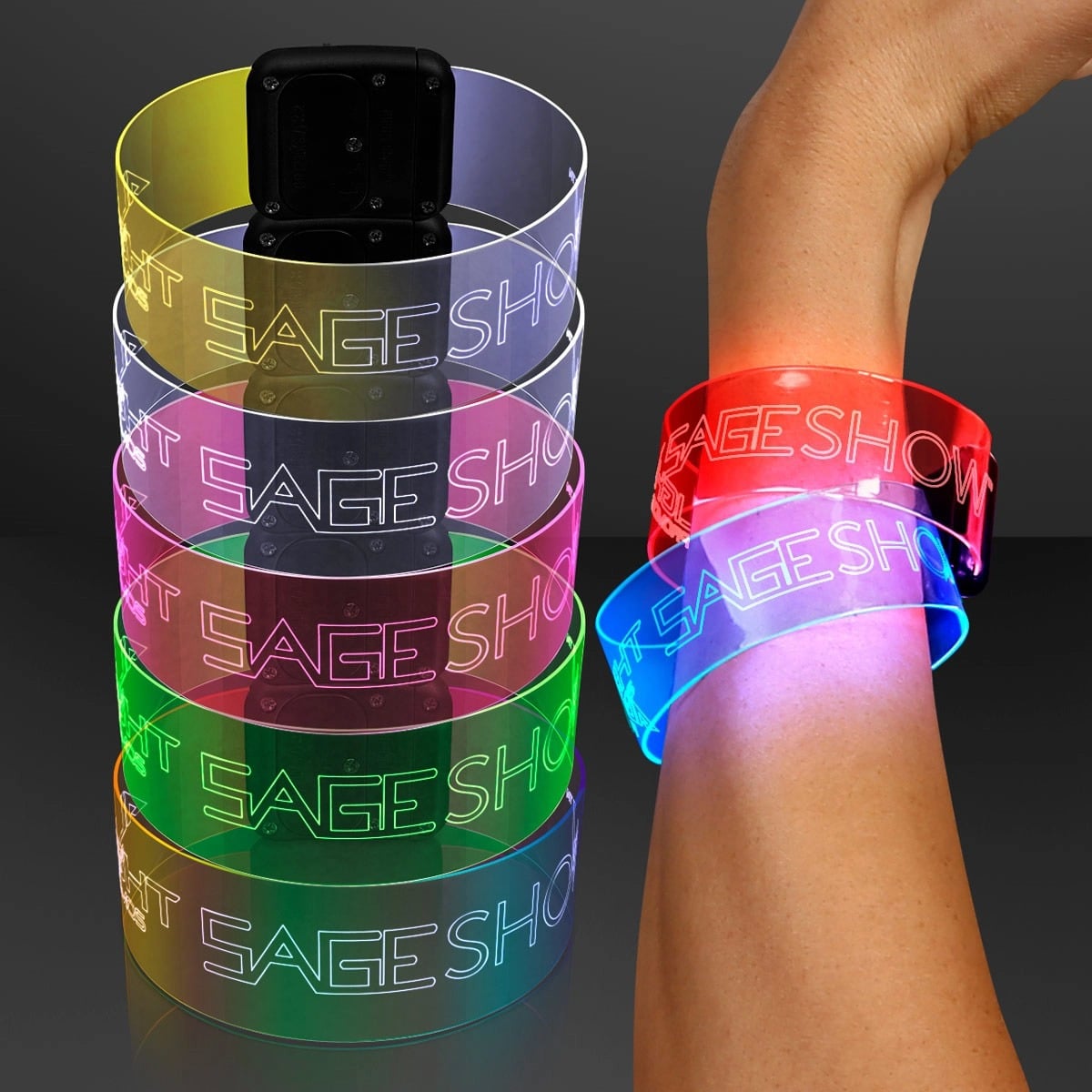 Cosmic LED Magnetic Clasp Bracelets in assorted colors, featuring "STAGE SHOW" text, are stacked beside a hand wearing two glowing wristbands—one red, one blue—with bright, vivid illuminated colors.