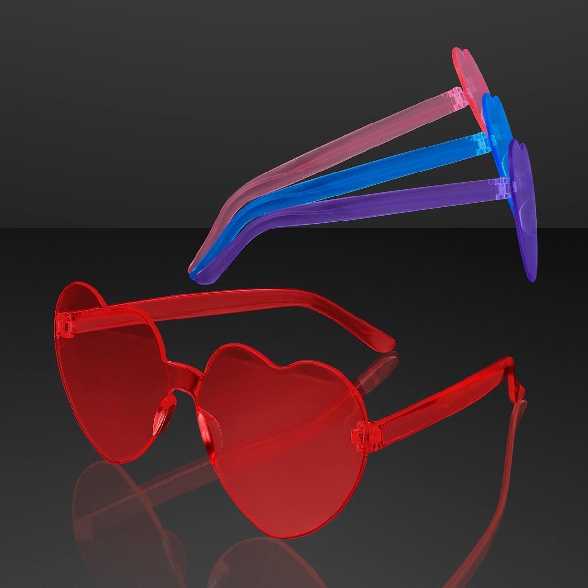 Cool Light Up Shades Party Glasses with heart-shaped red lenses and red frames in the foreground, and a pair with purple frames and blue-tinted lenses above, both set against a dark gray background.